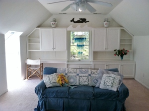 Bedroom or roomy den--your choice under the sweet sloped ceiling complete with 2 large skylights looking over the Chesapeake Bay. Custom built-ins fill one wall, making it home office friendly. I love the whimsy we added with the "waves" for our little mermaid. Storage ready window seat with lovely view through the trees to Elliot's Creek [Great place to catch blue crabs to steam up for dinner "Shh!"] Easy accessible storage on both sides of the eaves.[upstairs]